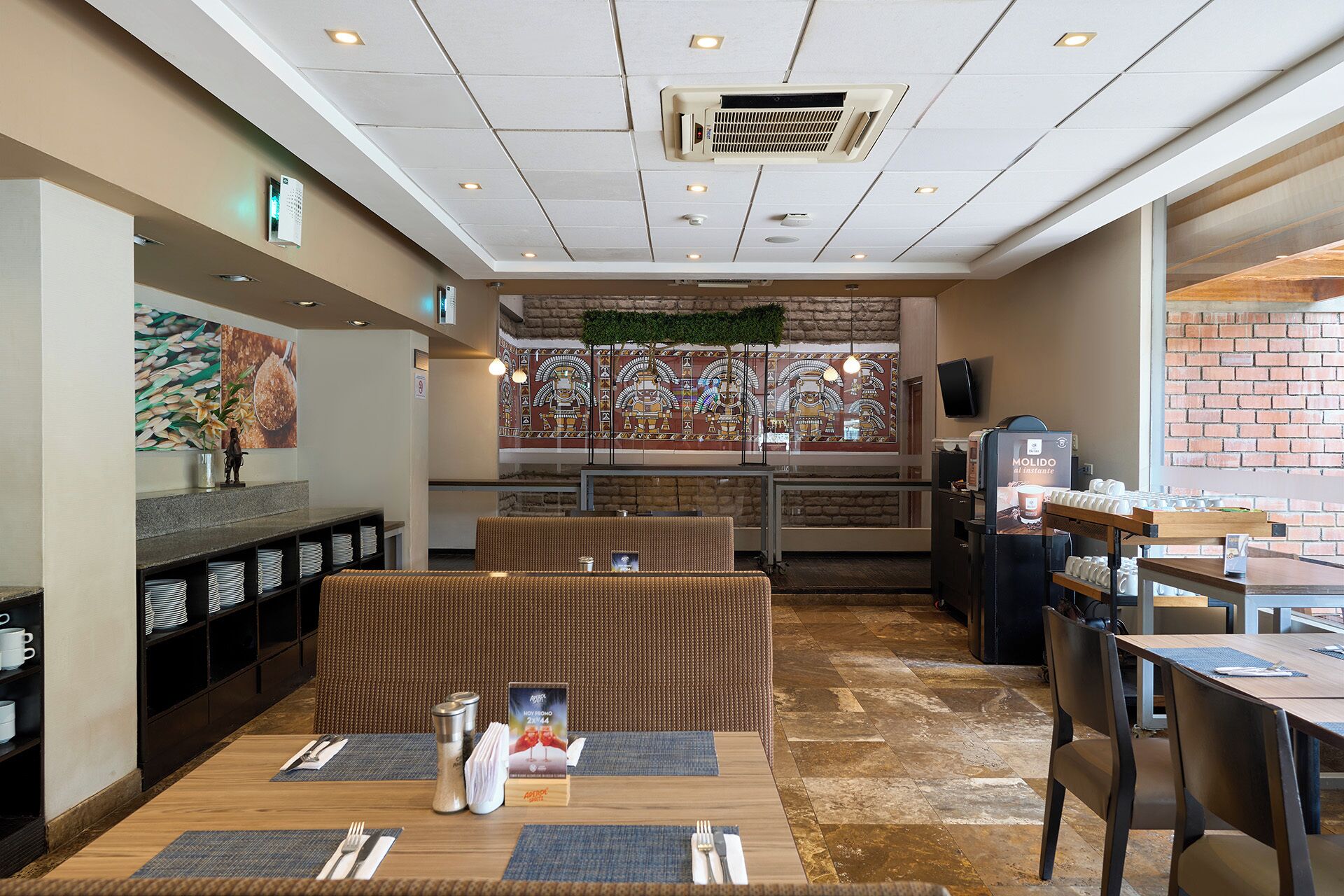 A restaurant interior with a bar area, seating, and a coffee machine.
