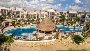 Relax by the central pool surrounded by amenities and enjoy stunning ocean views from the resort's multiple balconies.