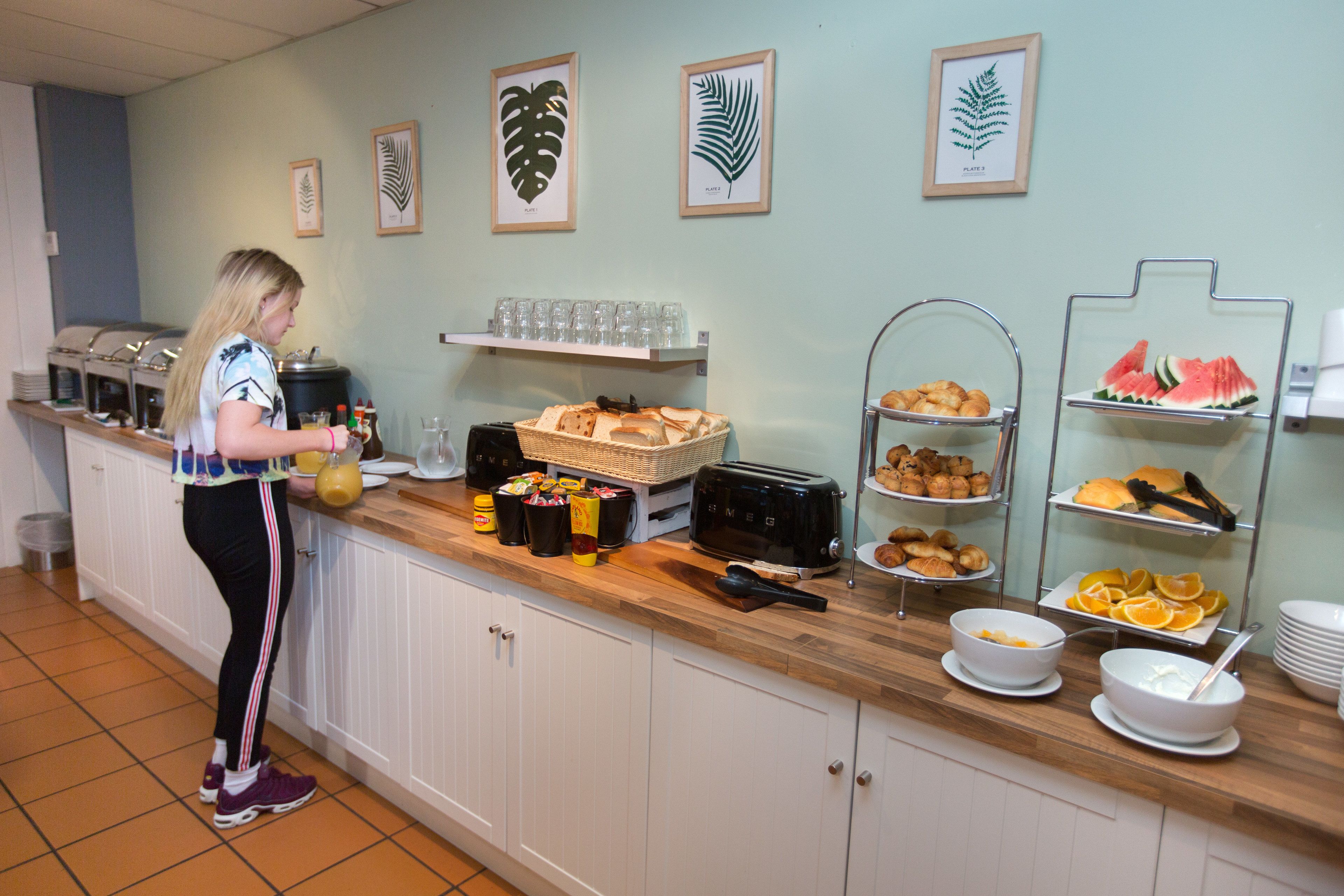 A breakfast buffet with various food items and beverages.