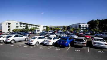 A parking lot with multiple cars parked in designated spaces.