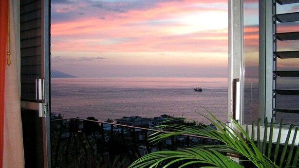 A balcony with a view of the sea at sunset. - Hotel Suites La Siesta (Puerto Vallarta)