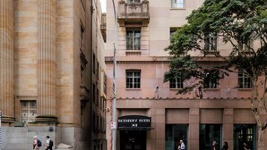 A historic building with classical architecture, including ornate columns and detailed balconies. - Rothbury Hotel (Brisbane)