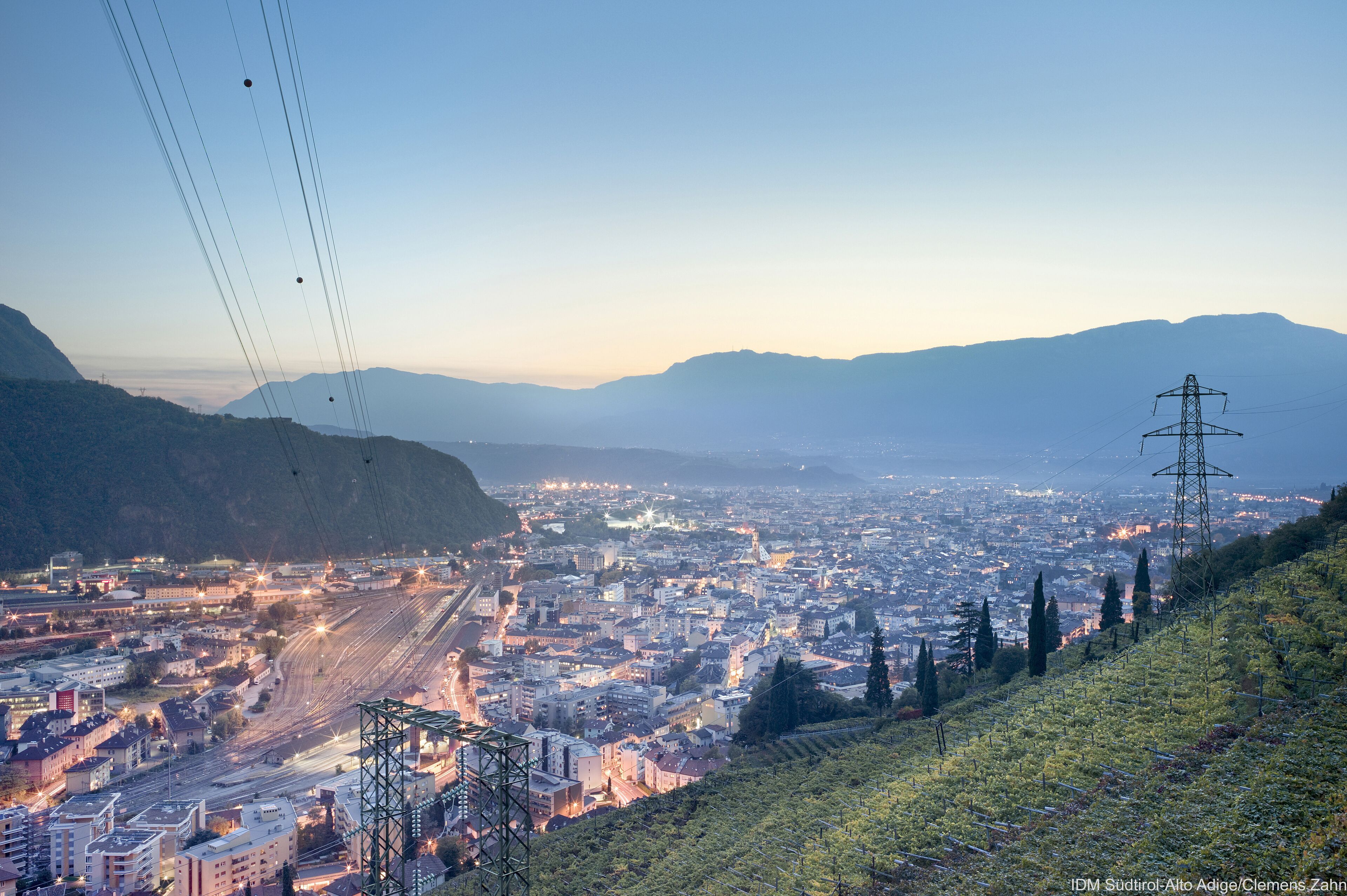 Un paisaje urbano con una autopista destacada y líneas de electricidad.