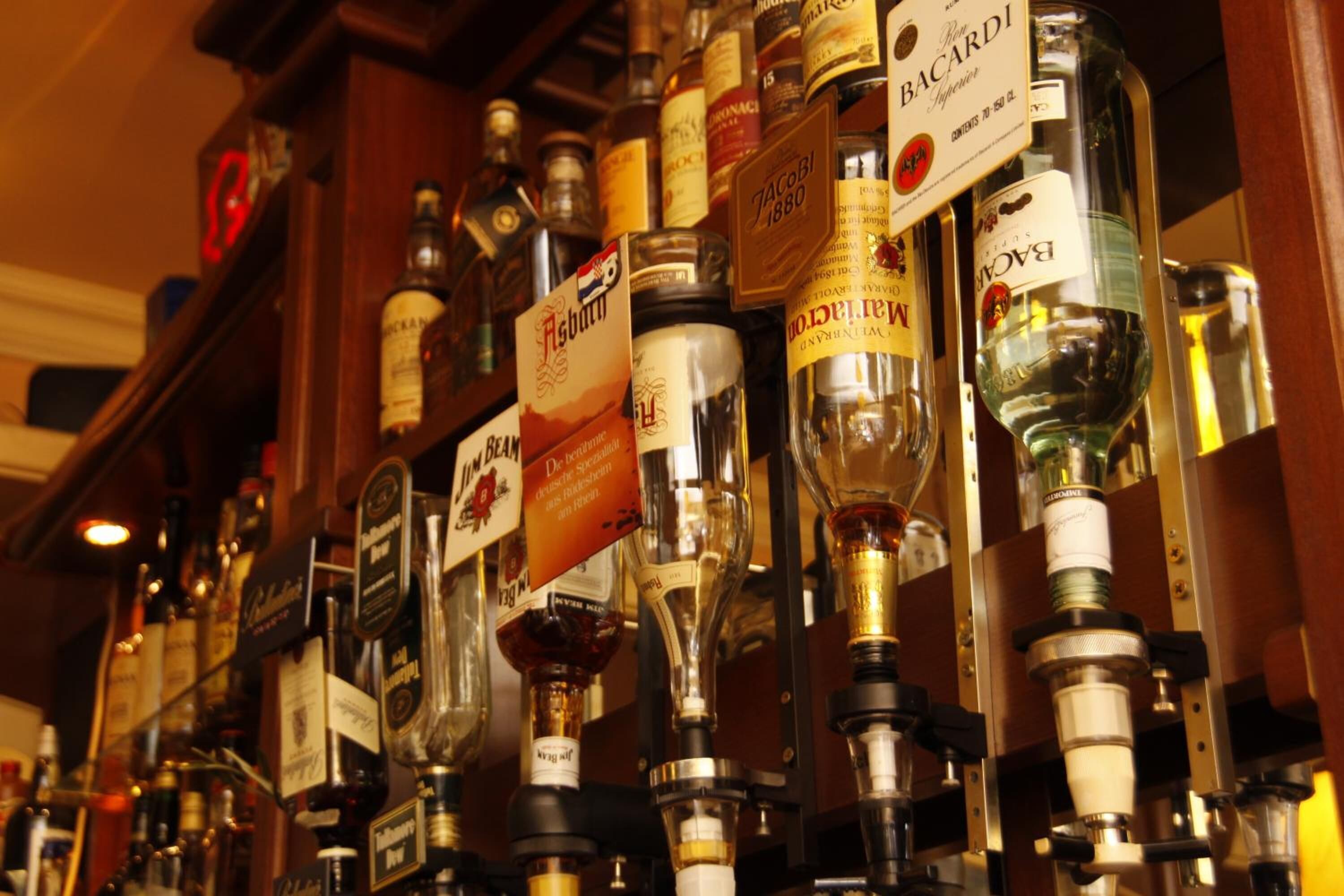 A bar with various liquor bottles and taps.