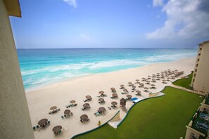 On the beach, white sand, sun loungers, beach umbrellas