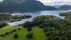 Un paysage montagneux avec un lac et une végétation luxuriante tout autour.