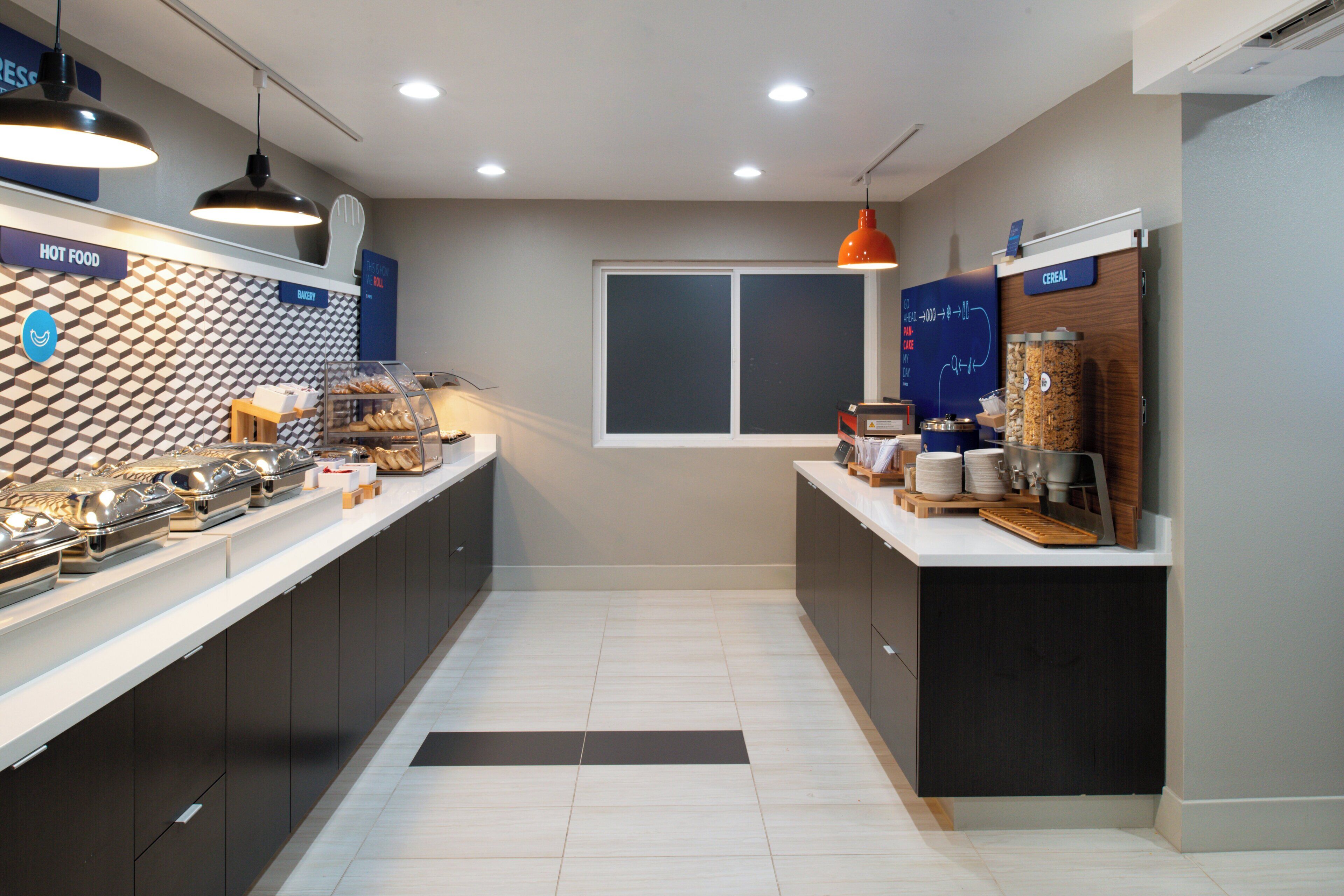 Una cocina moderna con barra desayunadora, área de panadería y exhibición de cereales.