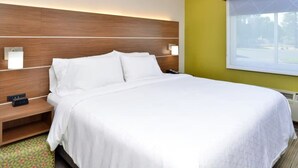 A hotel room with a wooden headboard, a bed with white bedding, a bedside table with a phone, and a window with a view. - Holiday Inn Express Santa Rosa North by IHG (Santa Rosa)
