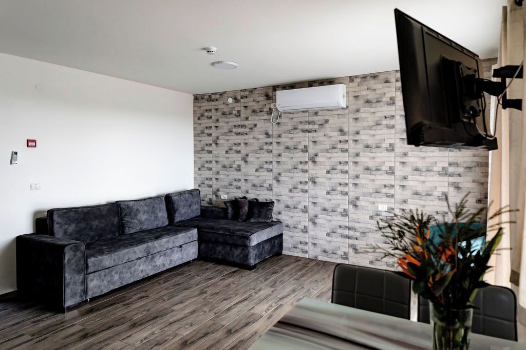 Family Apartment | Living area | 32-inch TV with cable channels, ping pong