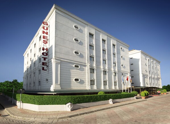 Experience the classic charm of Gunes Hotel, a beautifully designed building with a symmetrical facade and elegant entrance.