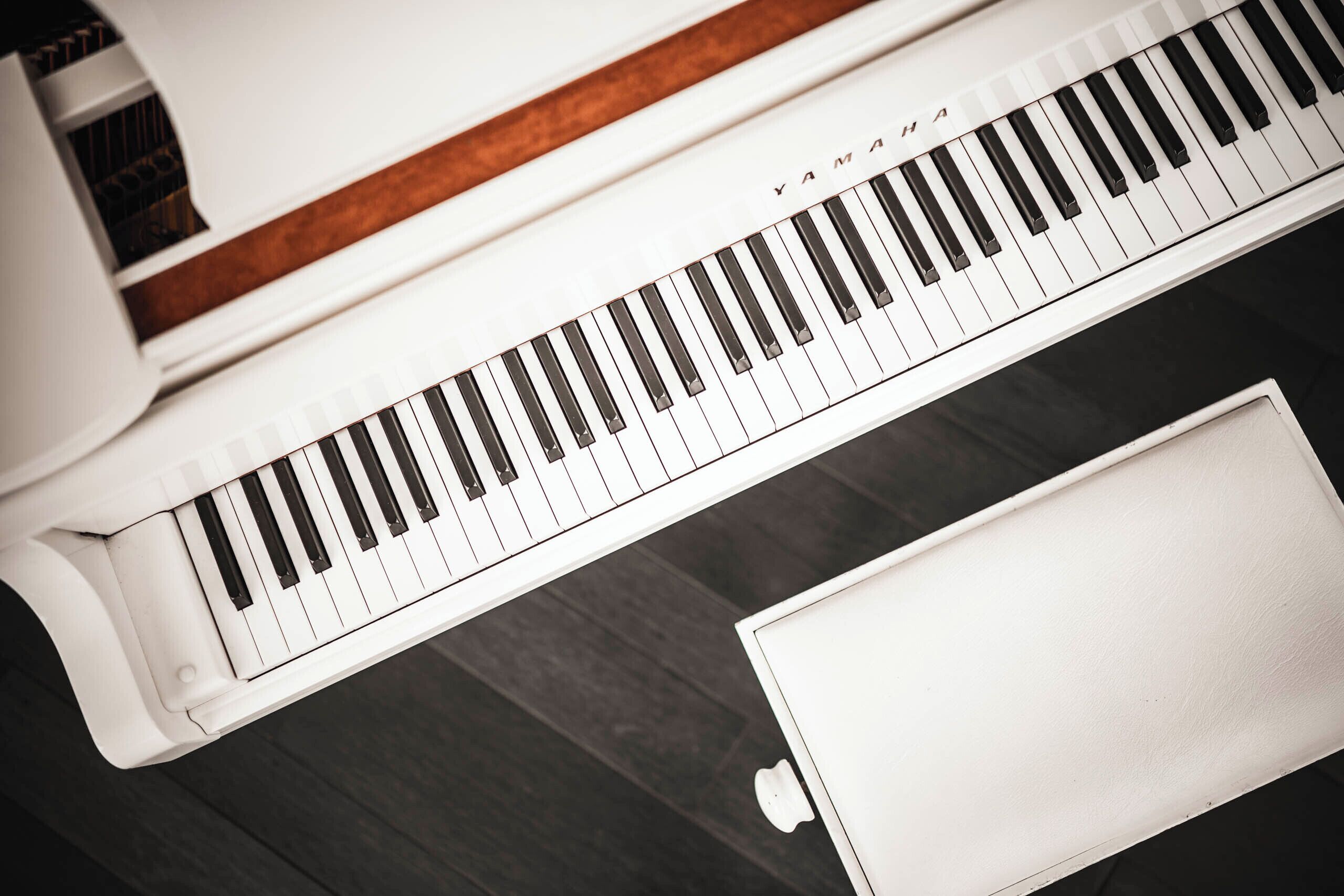 A piano with a wooden trim and a Yamaha logo.
