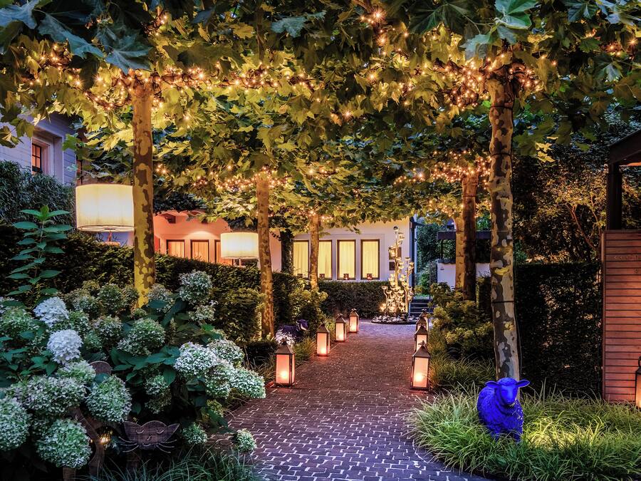 A garden pathway leading to a building with a reception area.