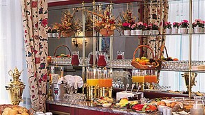 A bar area with a variety of drinks, food, and decorative items.