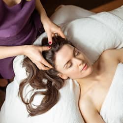 Guests can unwind in a serene hotel room with a plush bed and a soothing atmosphere.