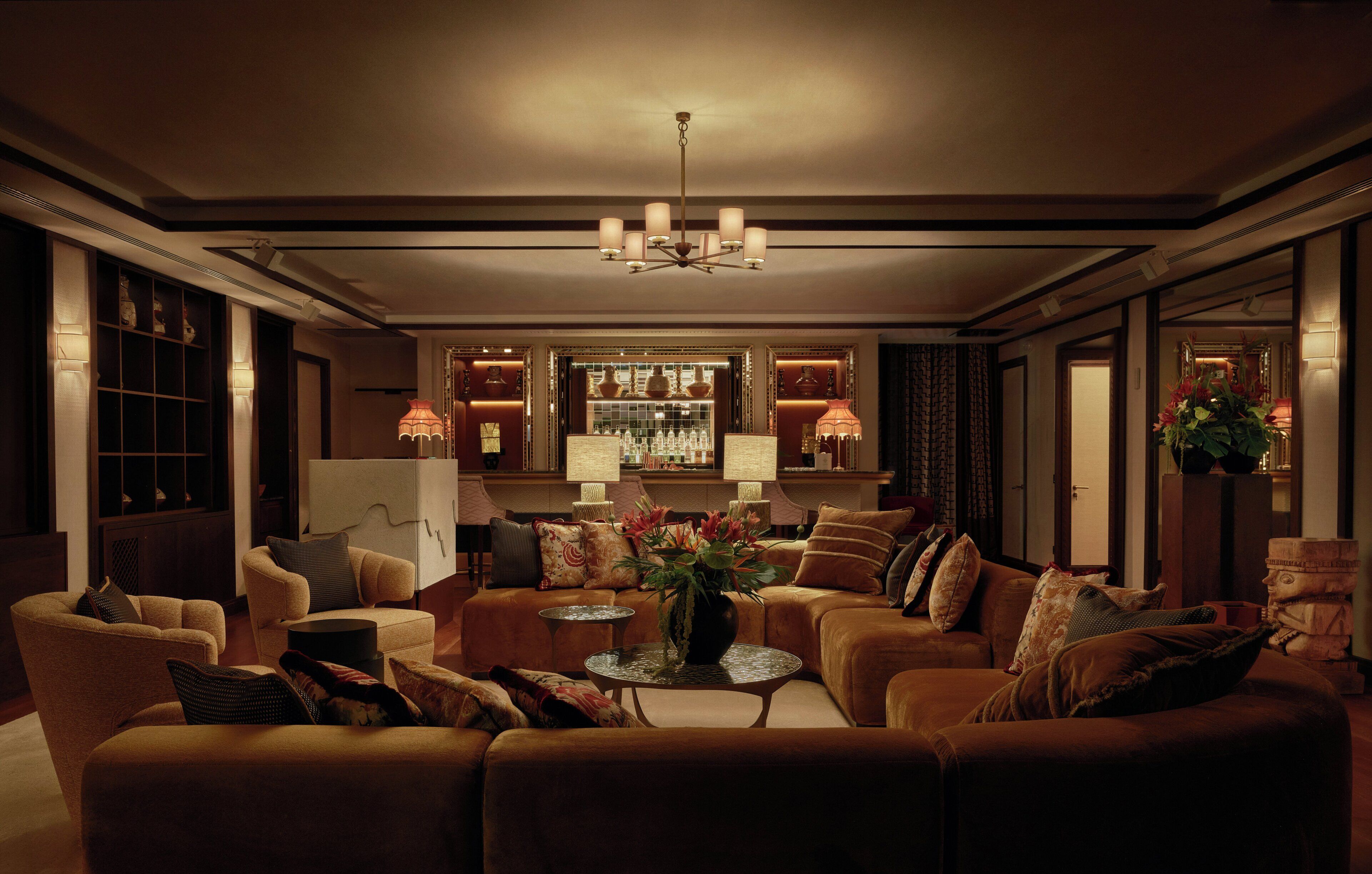 A well-lit living room with a sofa set, a coffee table, and a decorative vase.