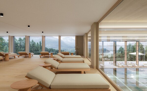 A spa room with multiple sun loungers, a glass pool, and a mountain view. - Suvretta House (St. Moritz)