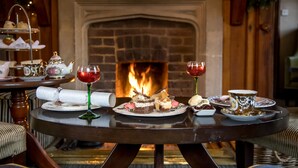 A table set for a meal with a fireplace in the background. - Langshott Manor (Horley)