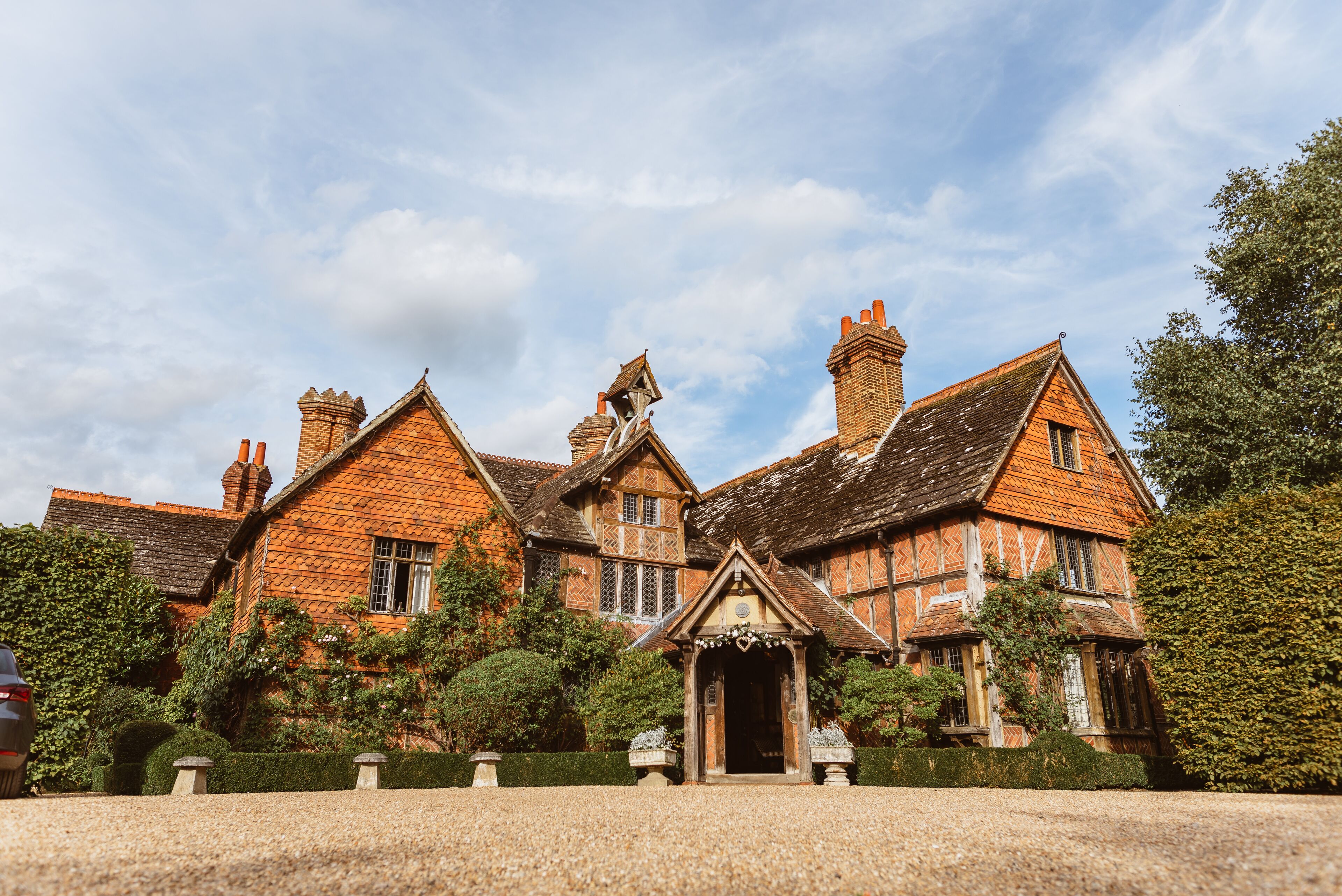 A large, traditional building with multiple chimneys and a prominent entrance.