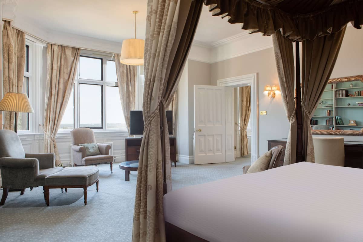 executive suite, 1 king bed, non smoking, garden view (four poster bed;with sofabed) | premium bedding, desk, laptop workspace, iron/ironing board