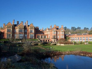 A large, historic building with multiple chimneys and a well-maintained lawn. - The Welcombe Hotel, Sure Hotel Collection by Best Western (Stratford-upon-Avon)
