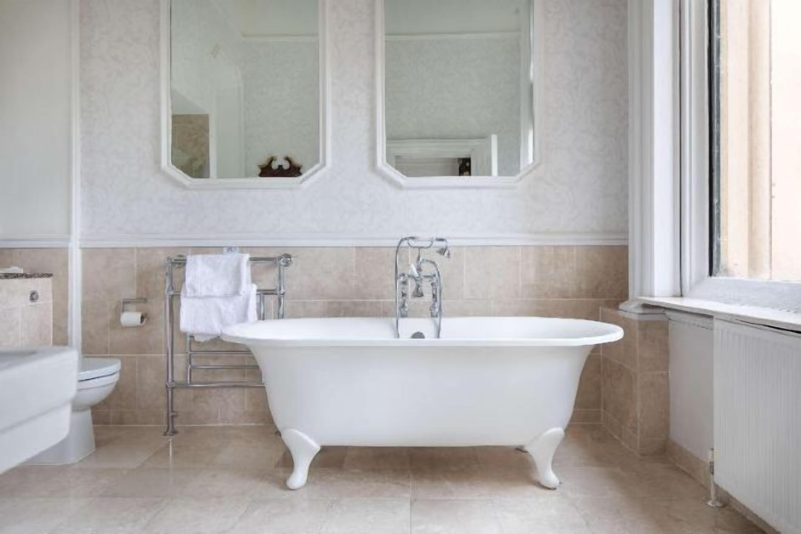 Badkamer | Een bad/douchecombinatie, een regendouche, gratis toiletartikelen