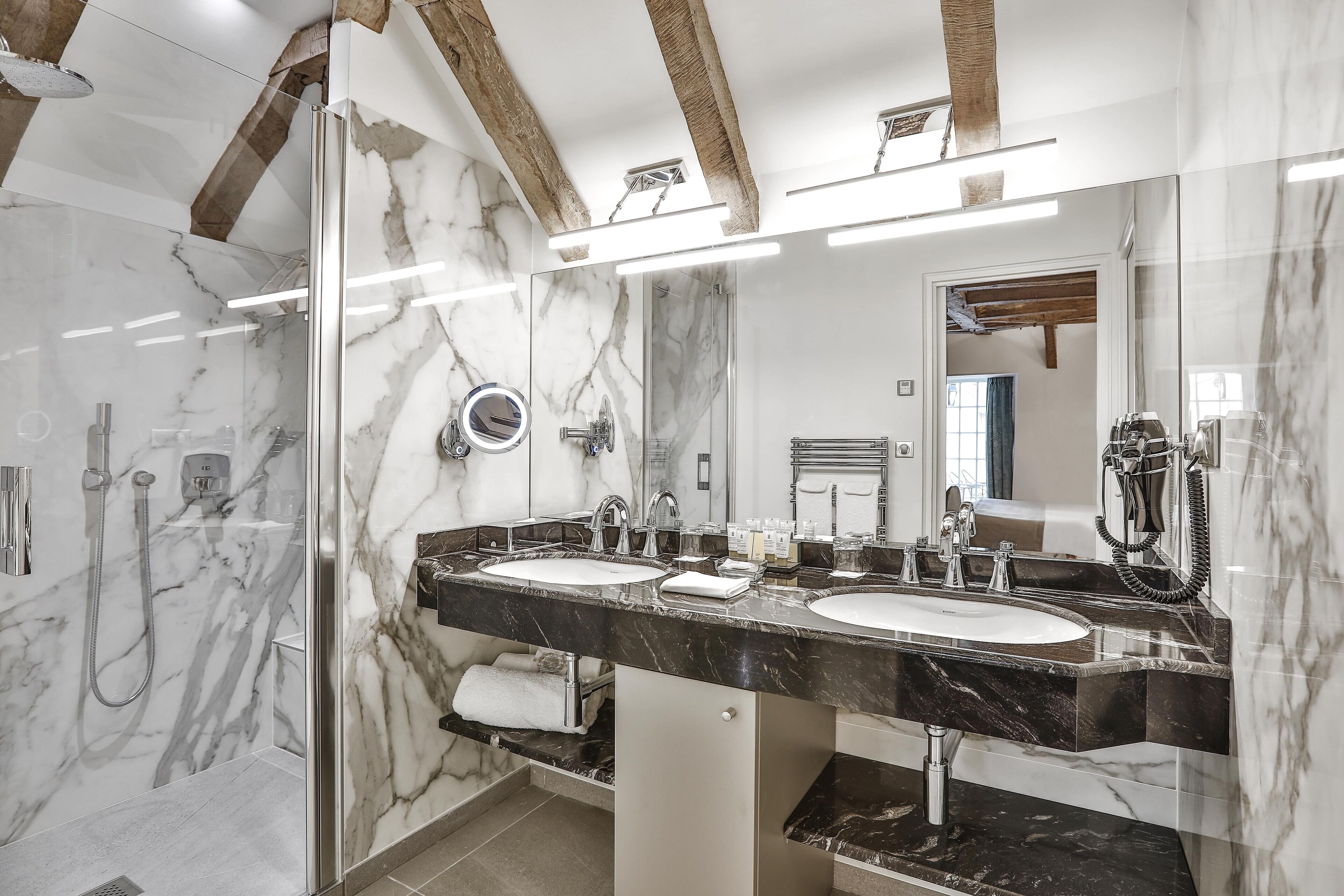 combined shower/bathtub, designer toiletries, hair dryer, bathrobes