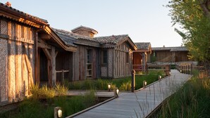 A wooden building with a wooden deck leading to it.