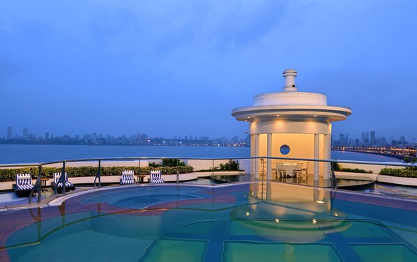 Una piscina al aire libre, sombrillas