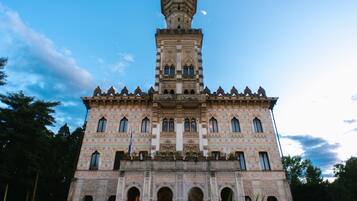 A historic building with intricate architectural details, multiple arches, and a prominent tower.