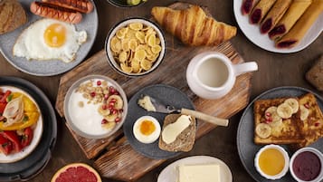 Enjoy a casual breakfast with a variety of options, including croissants, eggs, cereal, toast, and yogurt.
