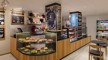 Mostrador de panadería con diversos pasteles y postres a la vista.