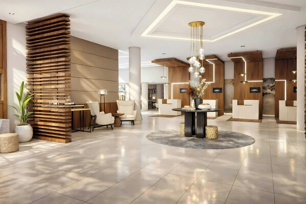 Un moderno vestíbulo de hotel con una zona de estar central, detalles de madera e iluminación contemporánea.