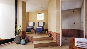 Relax in a serene spa room with a spacious shower area, comfortable seating, and ample storage.