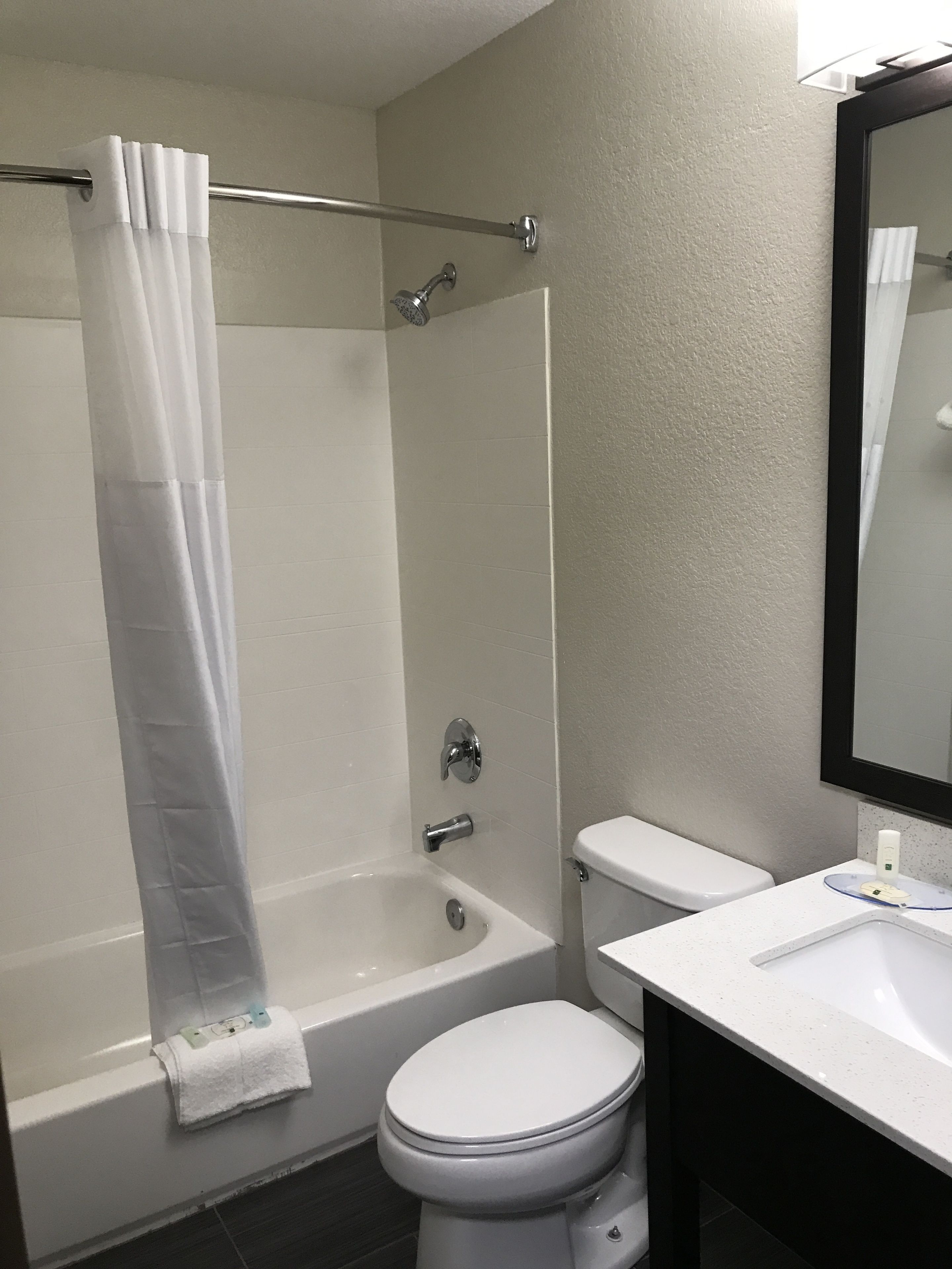 A bathroom with a bathtub, toilet, and sink.