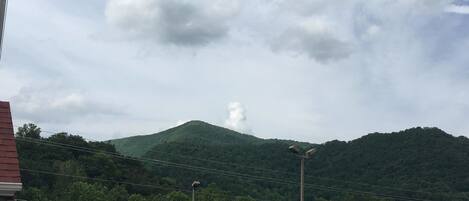 A mountain with a building in the foreground and a clear sky.