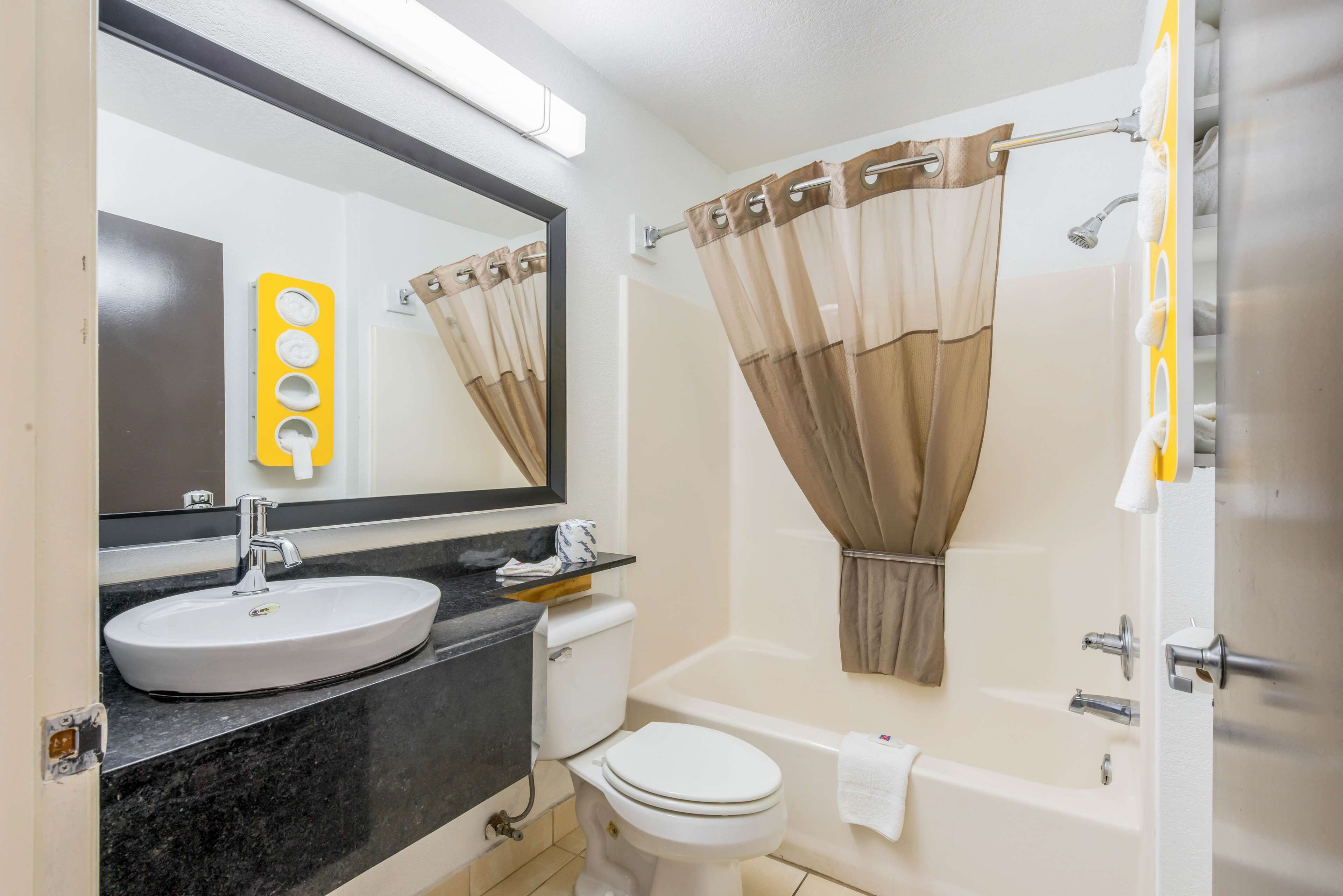 A bathroom with a sink, toilet, and bathtub.