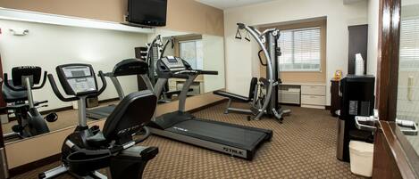 A gym with treadmills, ellipticals, and weight machines.