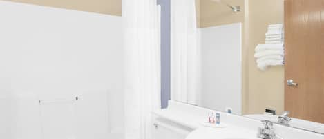 A modern bathroom with a bathtub, toilet, and sink.