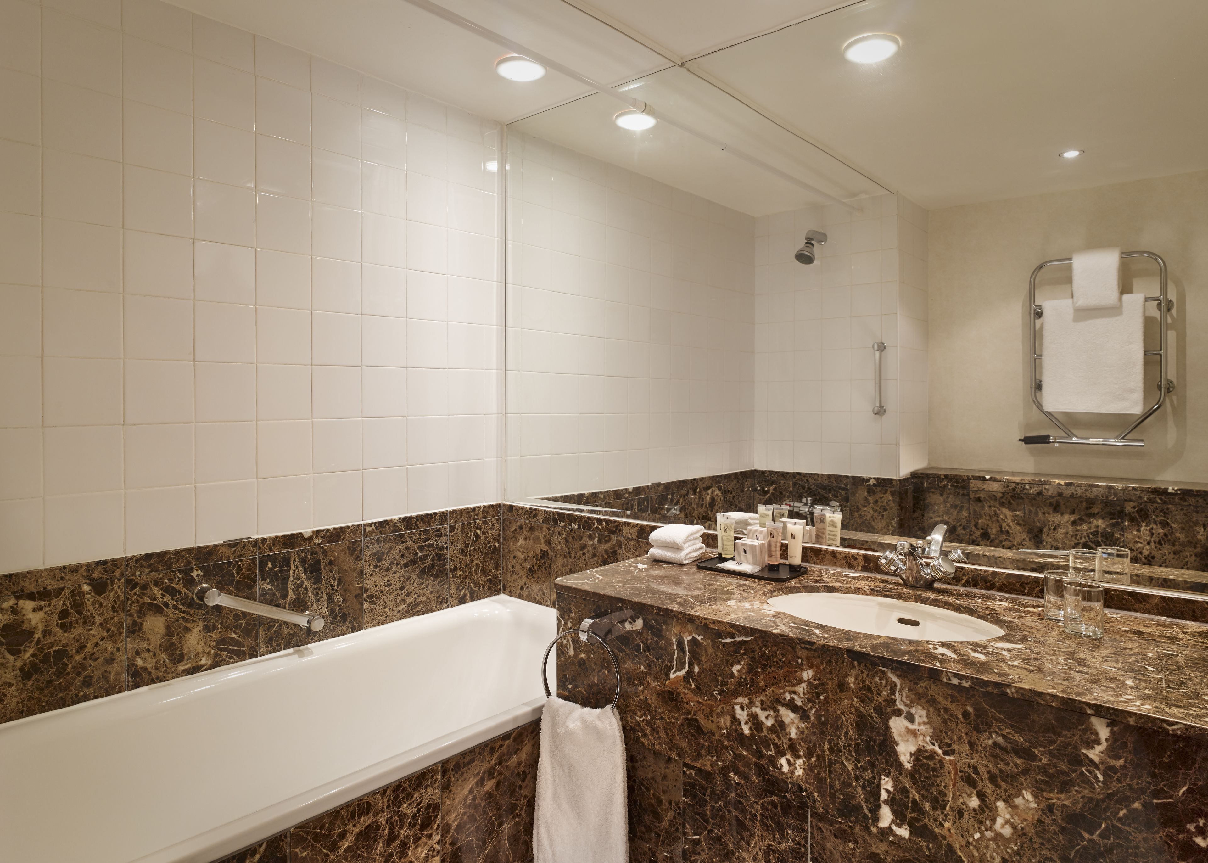 A modern bathroom with a bathtub, a sink, and a shower.