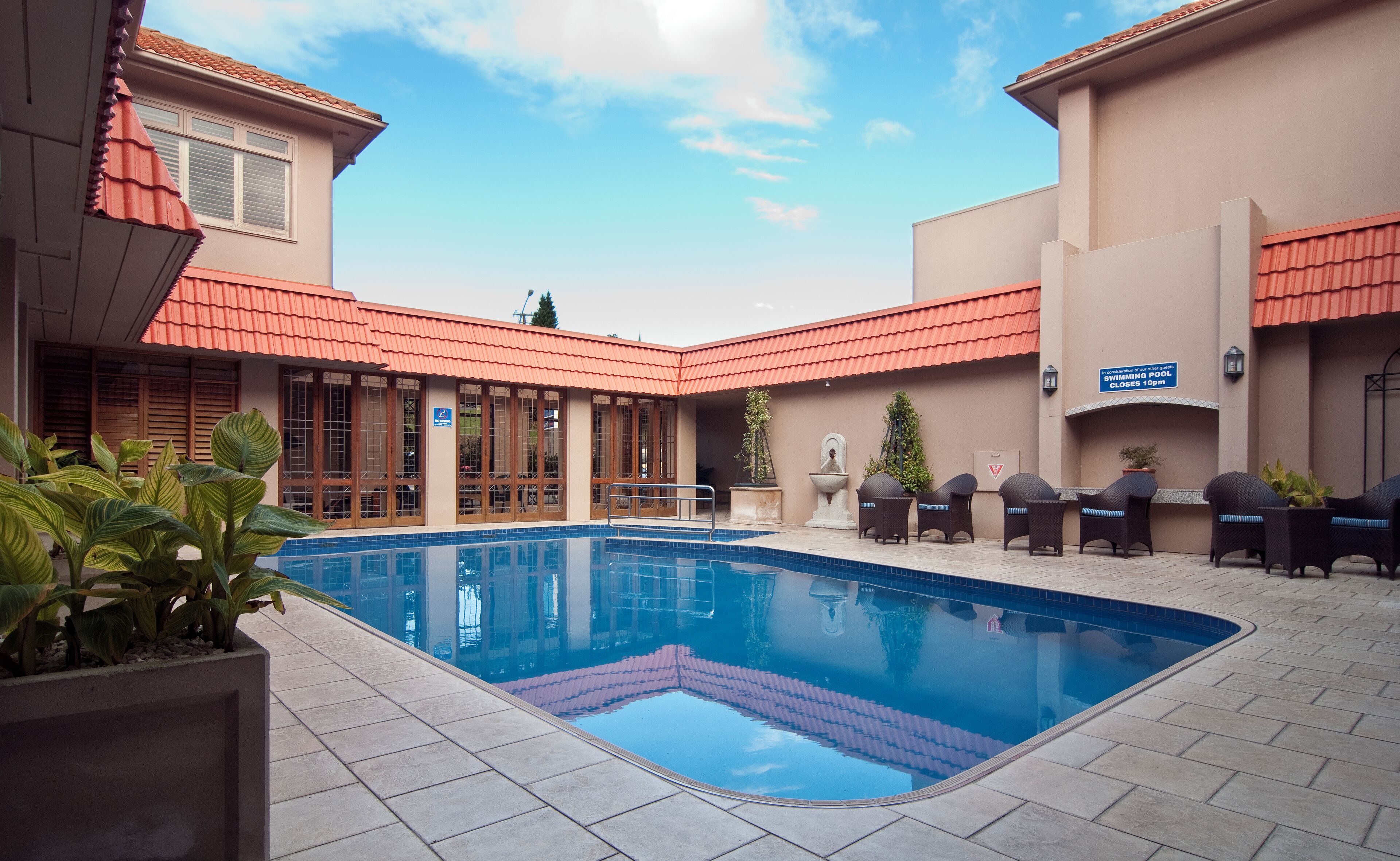 Outdoor pool, a heated pool, open 7:00 AM to 8:00 PM, pool loungers