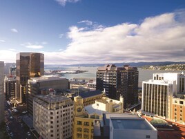 A cityscape with various buildings, including a prominent clock tower and a modern skyscraper.