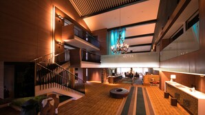 A spacious lobby with a wooden floor, a staircase, a chandelier, and a reception desk. - Niseko Northern Resort An'nupuri (Niseko)