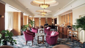 A hotel lobby with a reception desk, seating area with chairs, and a coffee station. - Hotel du Parc Hanoi (Hanoi)