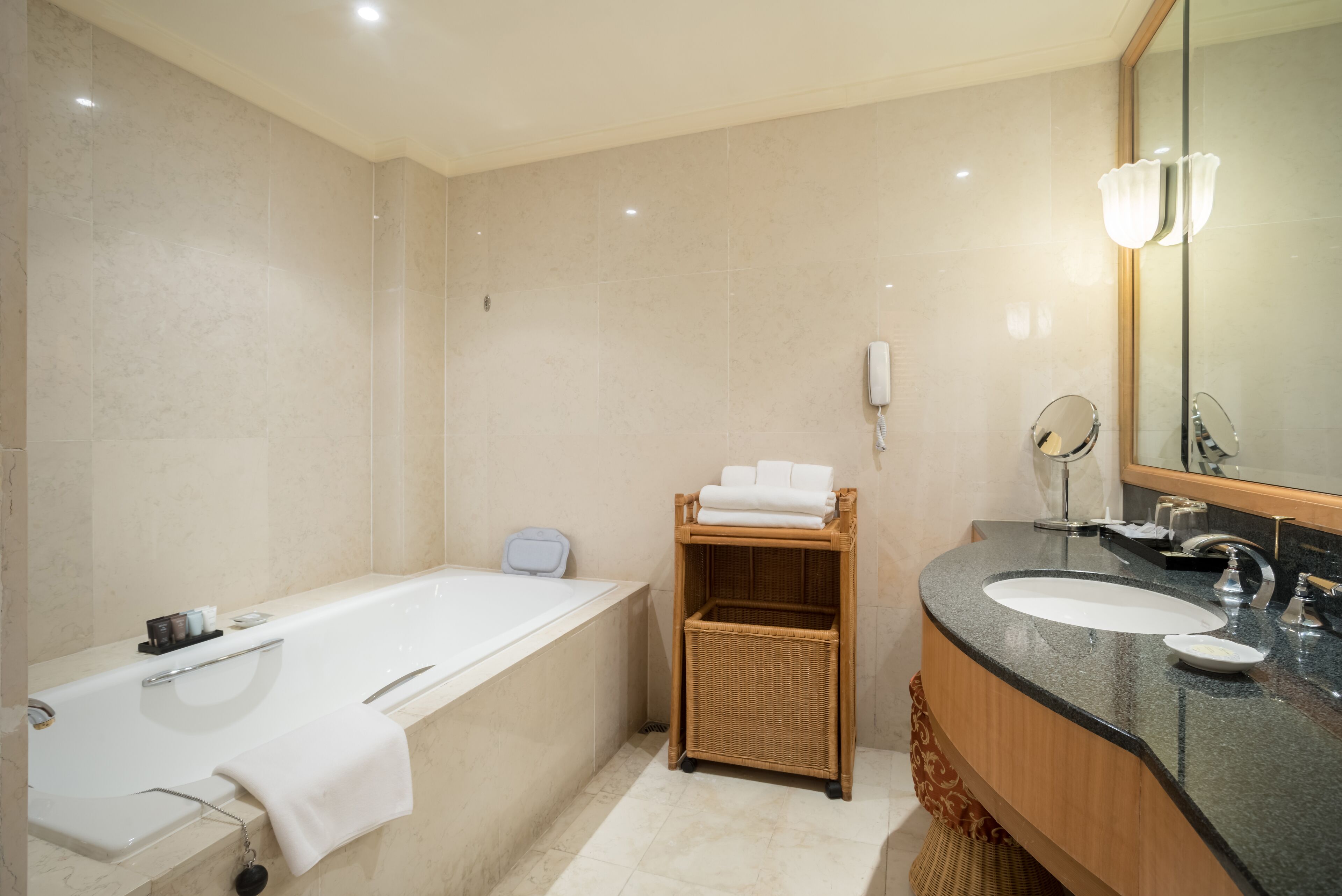 A modern bathroom with a bathtub, a sink, and a mirror.