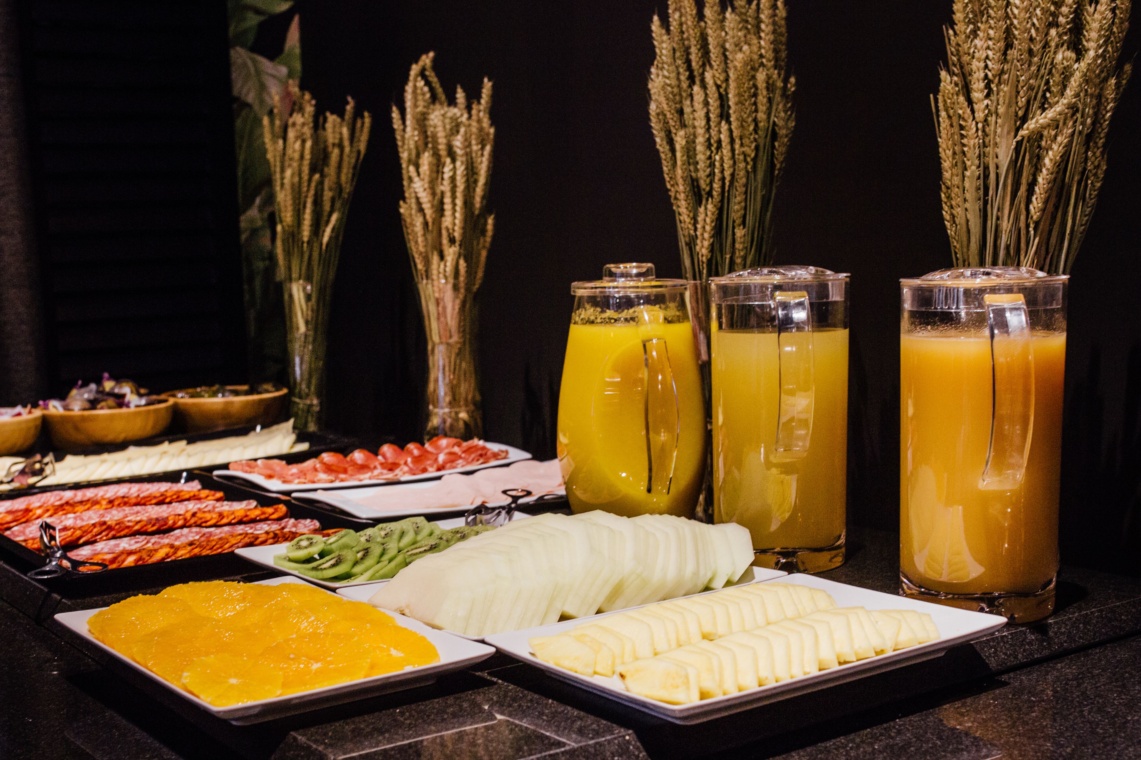 A buffet with various food items and drinks.