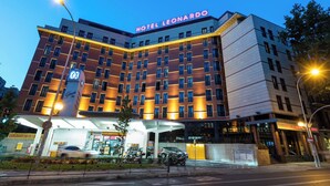 Een meerlaags hotel met een opvallend bord waarop 
