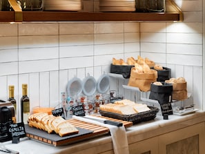 A breakfast buffet with bread, pastries, and condiments. - H10 Puerta de Alcalá 4* Sup (Madrid)