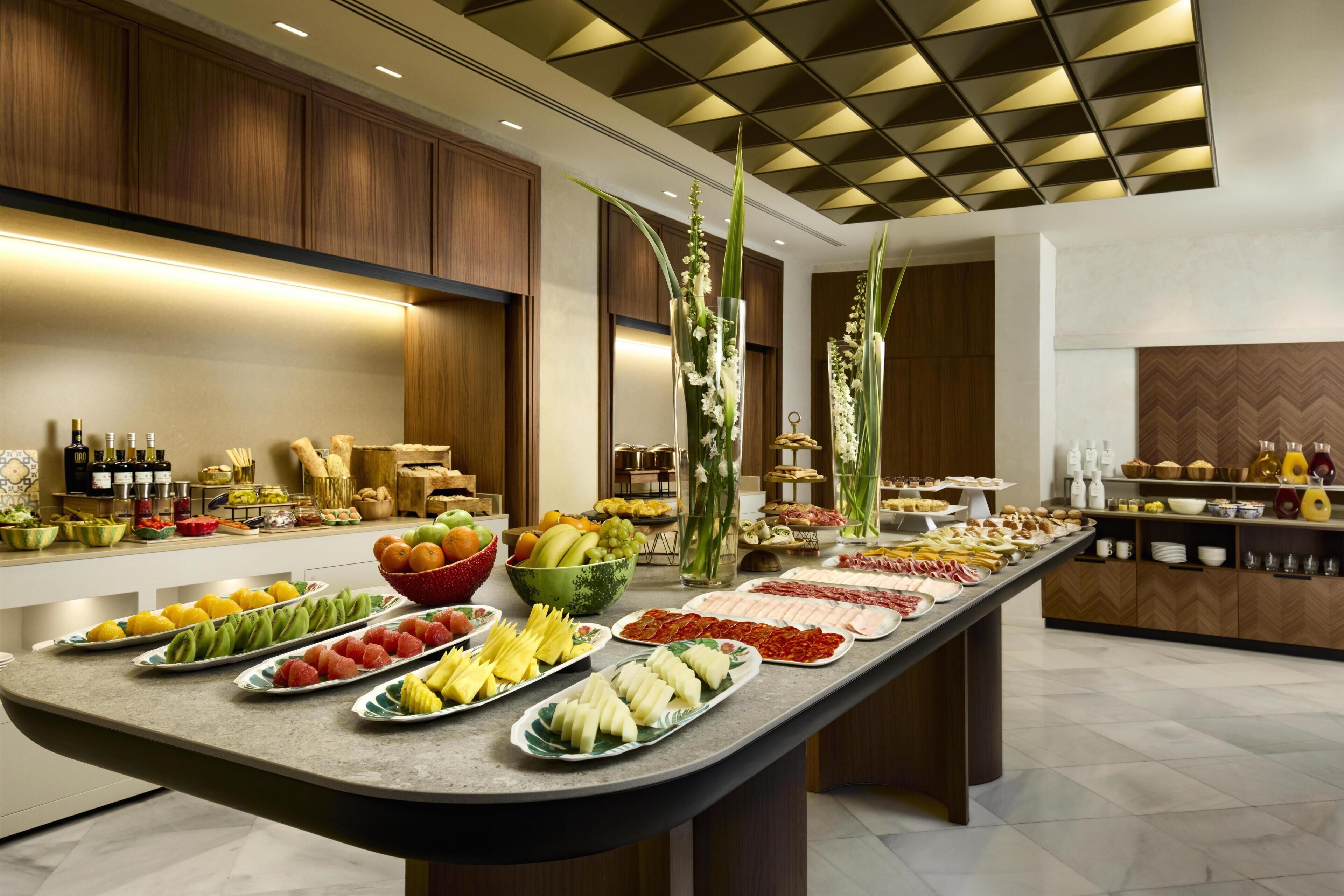 A buffet with various food items and beverages.