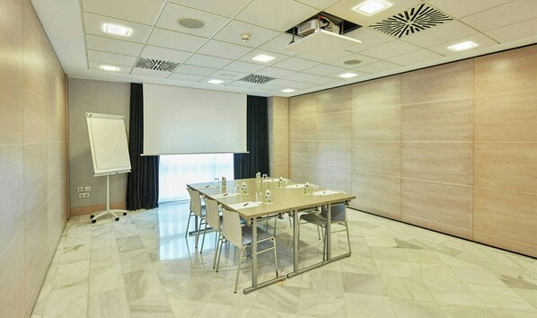 A conference room with a large table, chairs, a whiteboard, and a projector screen. - Sercotel Amistad Murcia (Murcia)