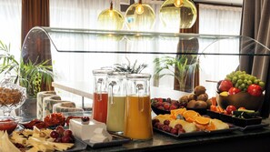 A breakfast buffet with various fruits, cheeses, and beverages. - Chic & Basic Velvet (Barcelona)
